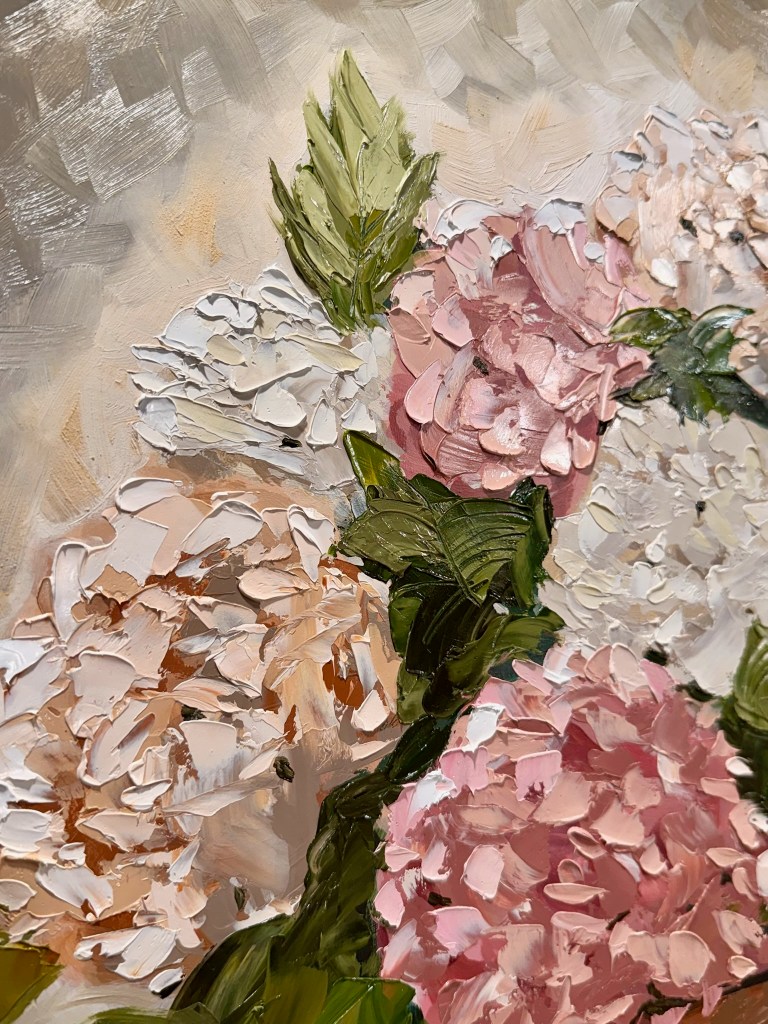 “Gentle Bloom” 18 x 24 oil on cradled wood panel

This painting reflects the thing I love most about oil painting, bold palette knife impasto! Layers of blush, ivory, and peach hydrangeas rise from a weathered, terracotta pot, with each stroke adding texture and depth.
